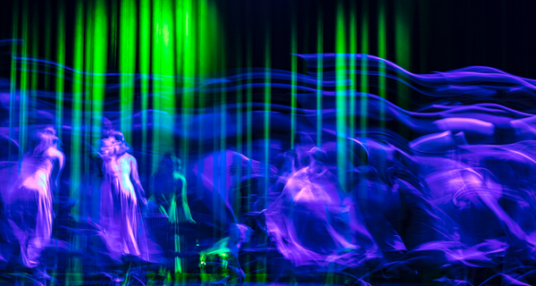 about six shadowy dancers in velvet and blue in front of a abstract black and green background